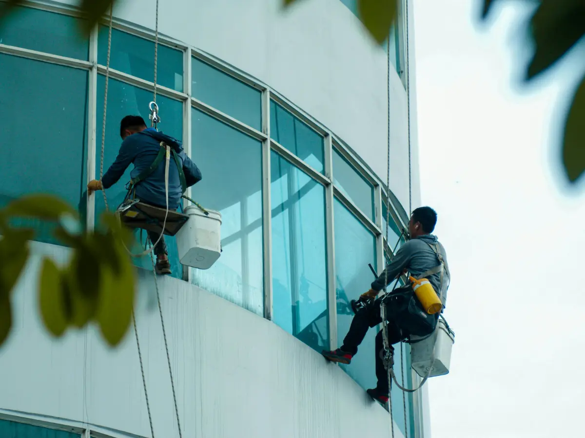 Commercial window cleaners using rope-access equipment