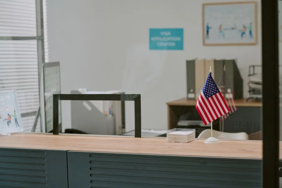 Reception desk at a government office with a U.S. flag, cleaned by a reliable government cleaning company.